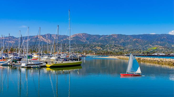 Mountains facing a harbor with boats under a clear blue sky Mountains facing a harbor with boats under a clear blue sky