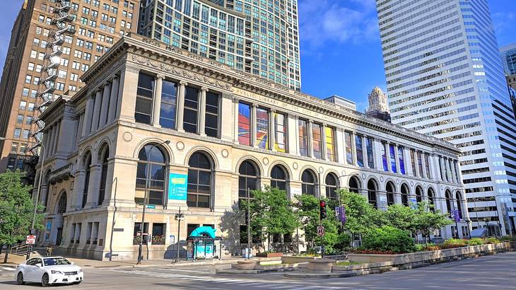 A contemporary building with arched glass windows against tall buildings A contemporary building with arched glass windows against tall buildings