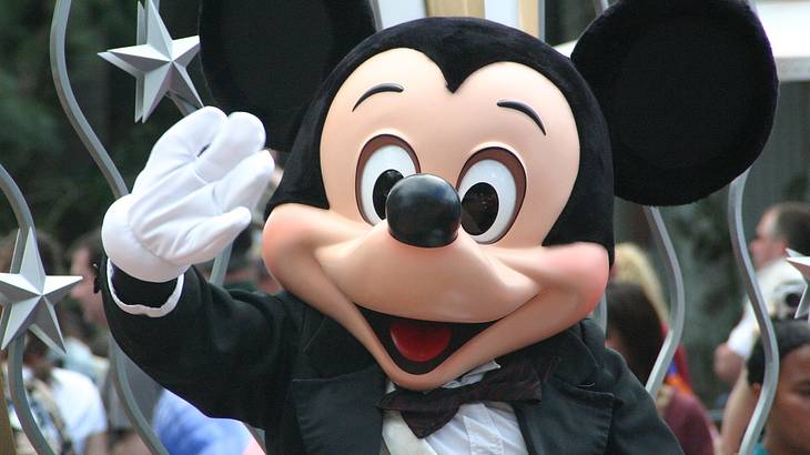 Mickey Mouse waving at the crowd at Disney World in Orlando, Florida