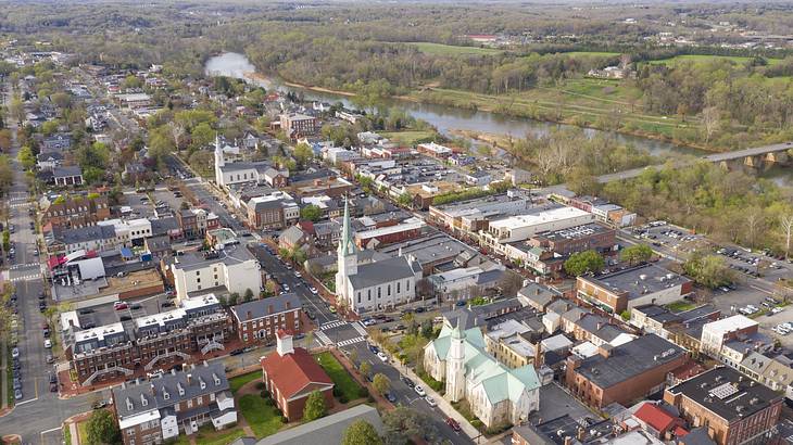 Aerial view of a town with historic buildings and a nearby river with trees