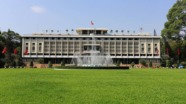 Outside grassy area with a fountain in front of the Independence Palace in Vietnam Outside grassy area with a fountain in front of the Independence Palace in Vietnam