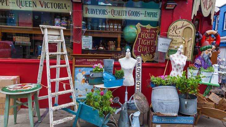 Vintage items outside a shop with a. red facade