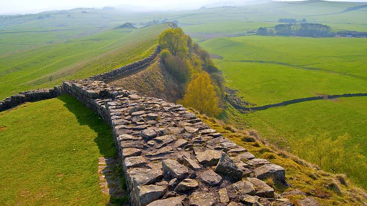 Hadrian's Wall across green rolling hills is one of the famous English landmarks