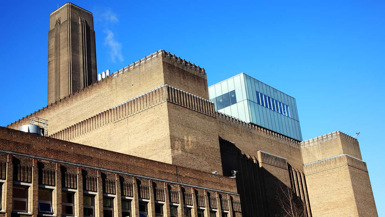A large building with a tower under a clear blue sky