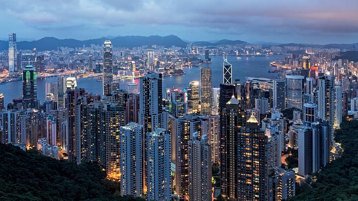 View of city buildings and lights from a peak at sunset, Hong Kong View of city buildings and lights from a peak at sunset, Hong Kong