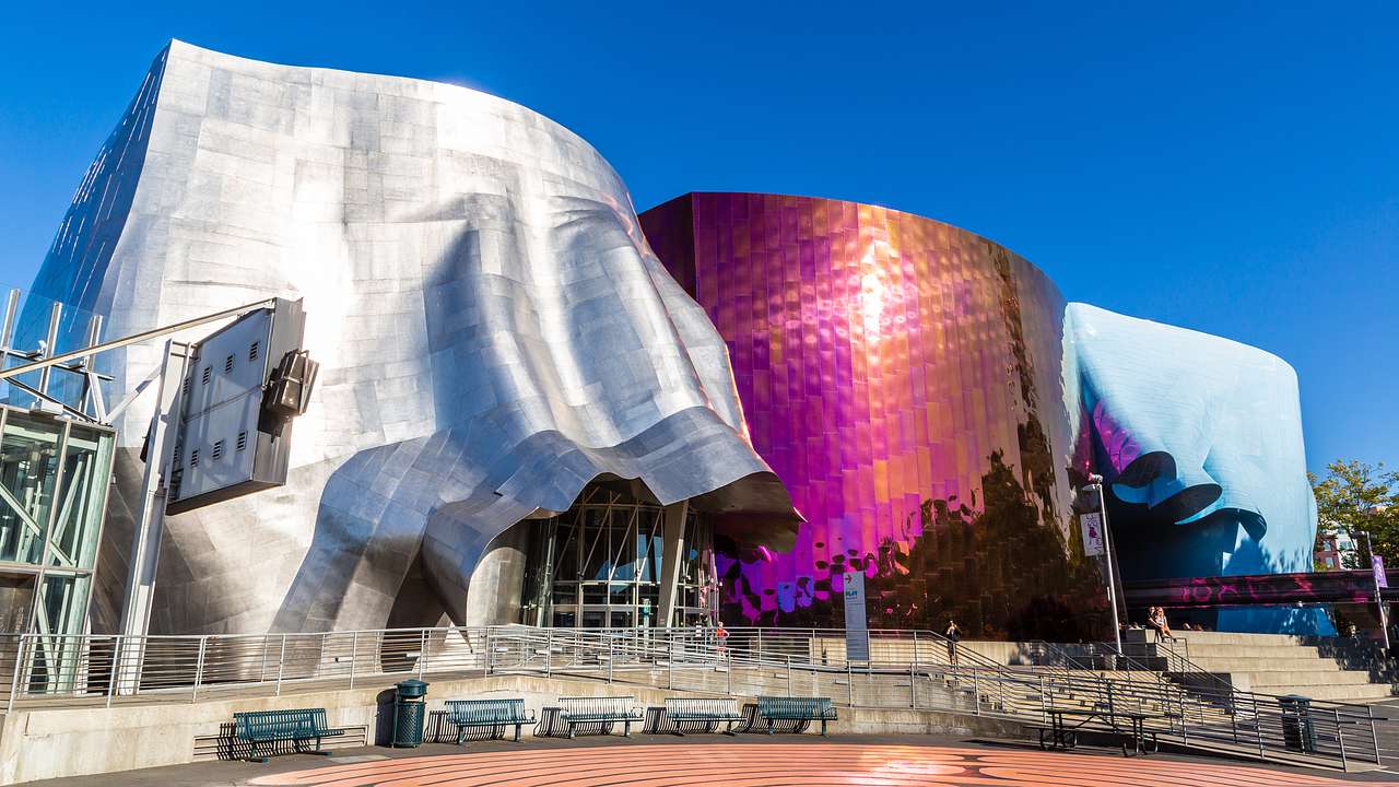 The silver, purple, and blue exterior of the Museum of Pop Culture on a sunny day