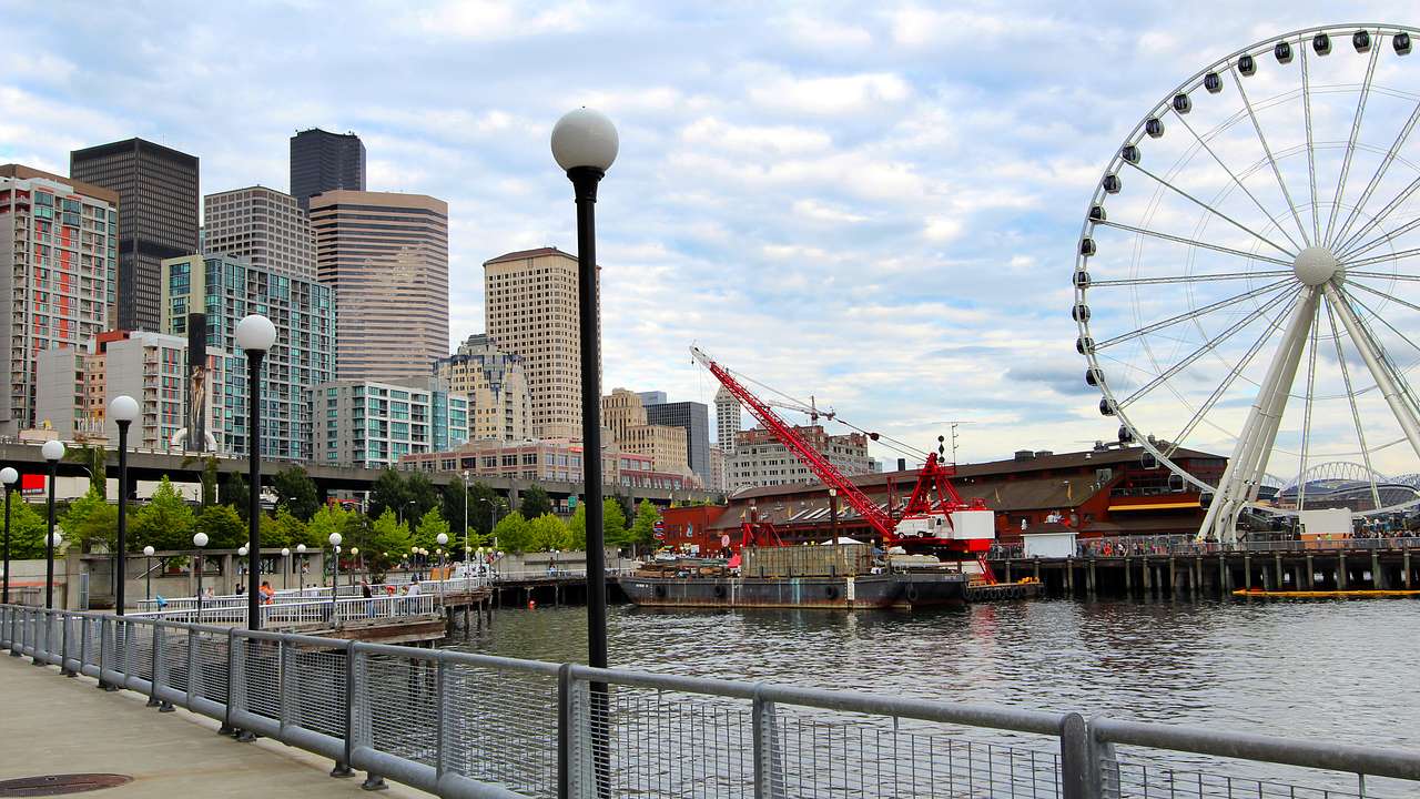 A body of water with a bridge and buildings in the background