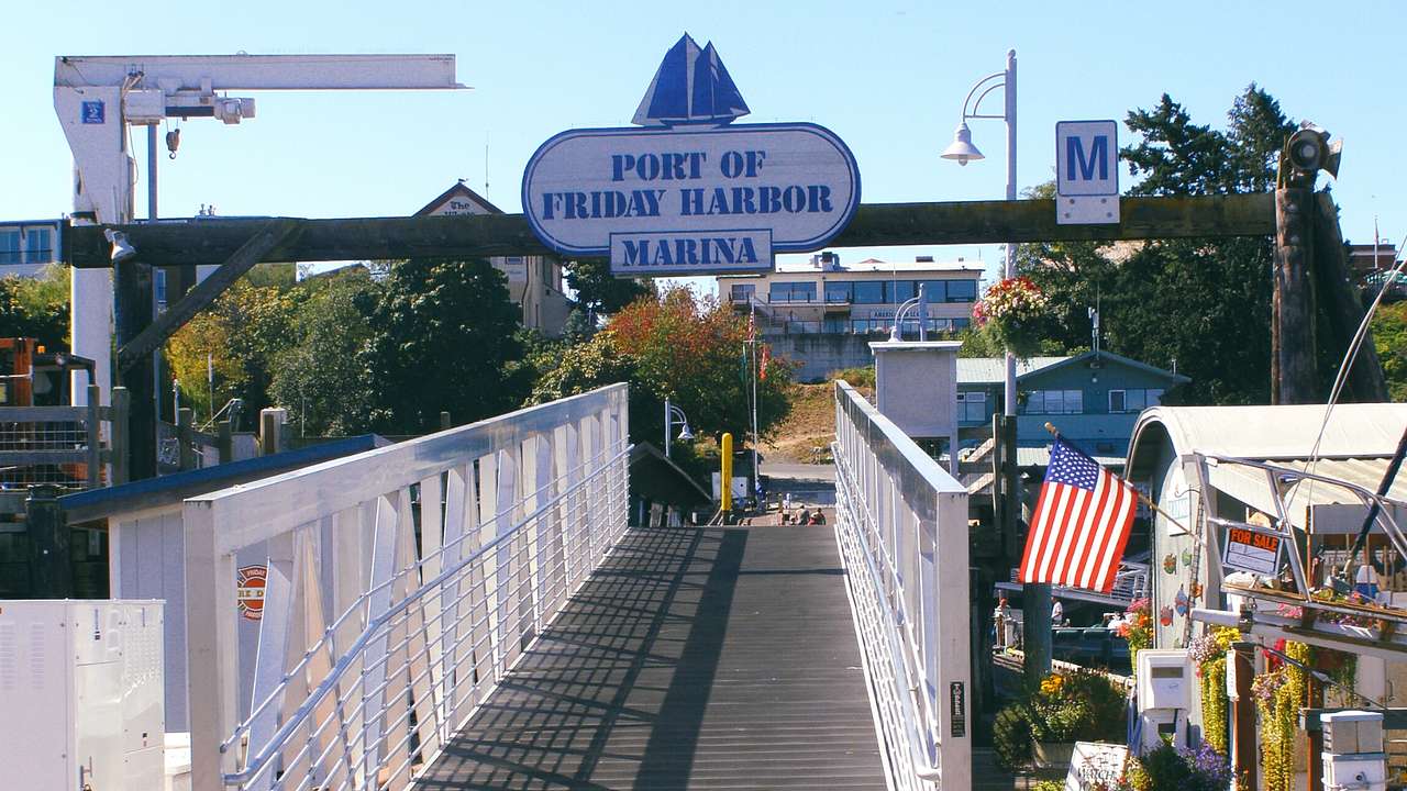 A bridge at a marina, a US flag, and a sign that says "Port of Friday Harbor Marina"