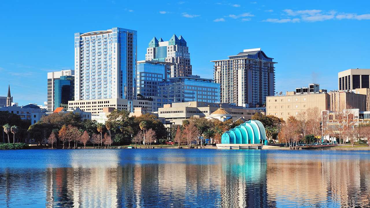 A building with a blue dome and a body of water with buildings in the background