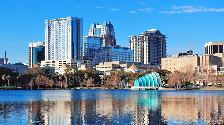 A building with a blue dome and a body of water with buildings in the background