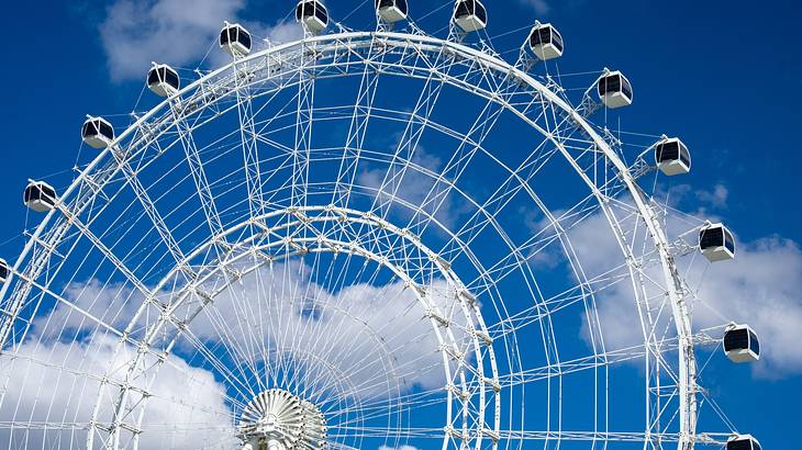 Large white Ferris wheel under a bright blue sky