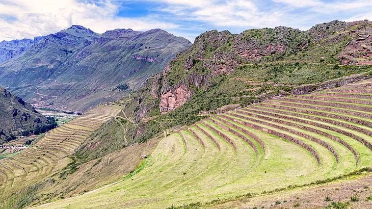 Green mountain slopes with descending layers of grass fields Green mountain slopes with descending layers of grass fields
