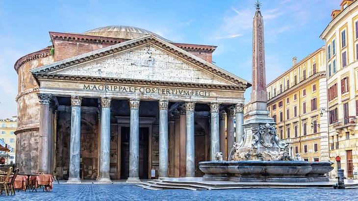The majestic building of the Pantheon in the middle of a square facing a pillar