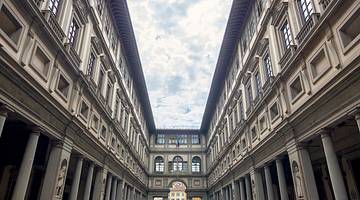 A wide-angle shot of the interior courtyard of the Uffizi Gallery in Florence