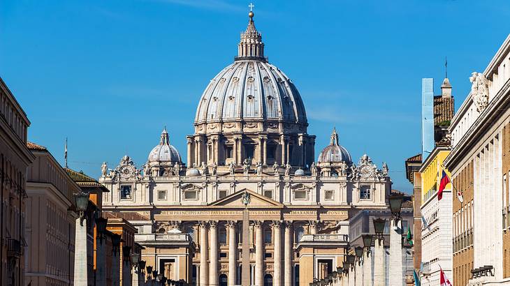 St. Peter's Basilica's exterior and dome against a partly cloudy sky