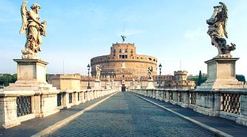 Castel Sant'Angelo's façade from street level with a walkway and two angels in front
