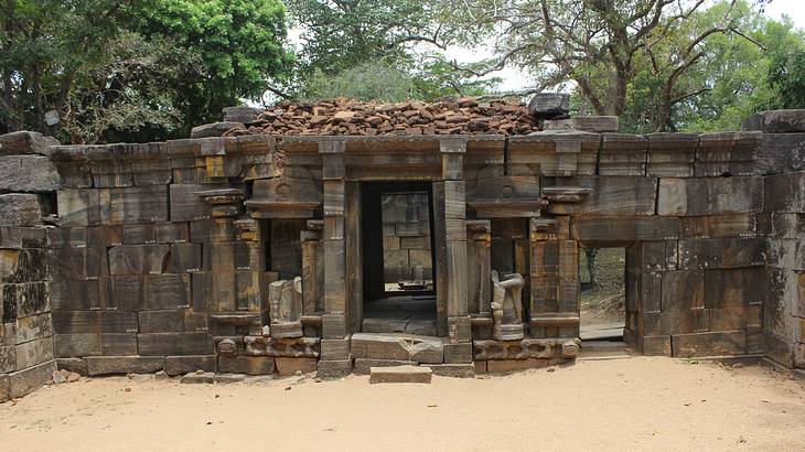 Old ancient building with a large door and old stones surrounding