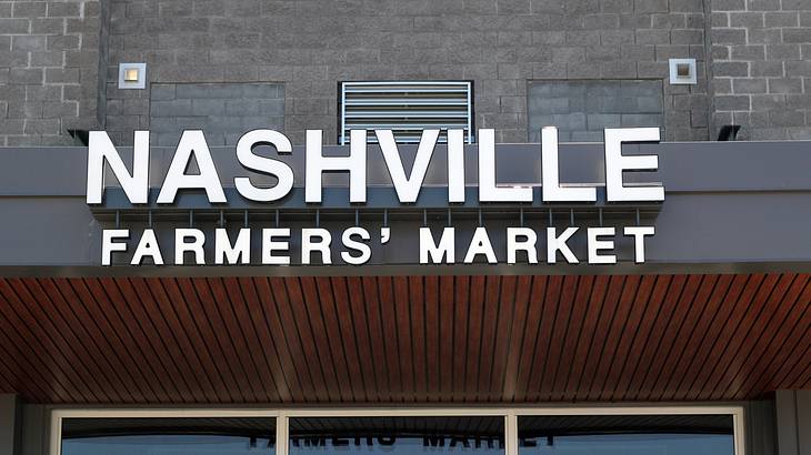 A building with a sign that says "Nashville Farmers' Market" A building with a sign that says "Nashville Farmers' Market"