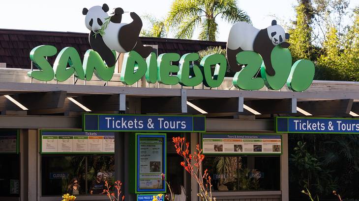 A green sign "San Diego Zoo" with pandas on it