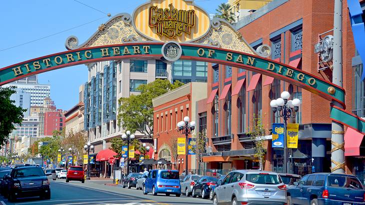 A street with buildings and an arch with the words "Historic Heart of San Diego"