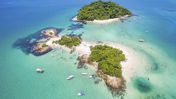 A group of small islands with sandy beaches surrounded by emerald water from above