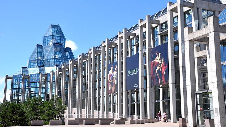 A large building with floor-to-ceiling windows topped with a cluster of glass prisms