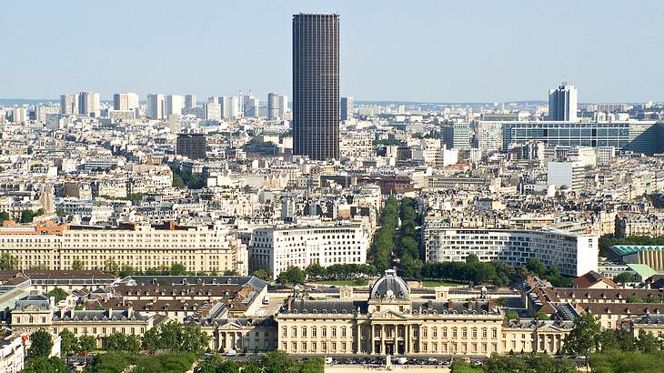 Aerial view of a city skyline with a tall black building in the middle