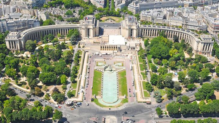 Aerial view of an open park with trees and buildings surrounding it