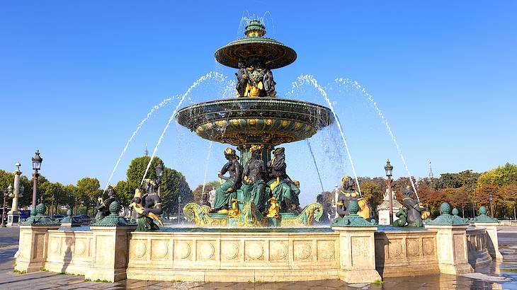 A beautiful fountain with water spraying out from multiple statues