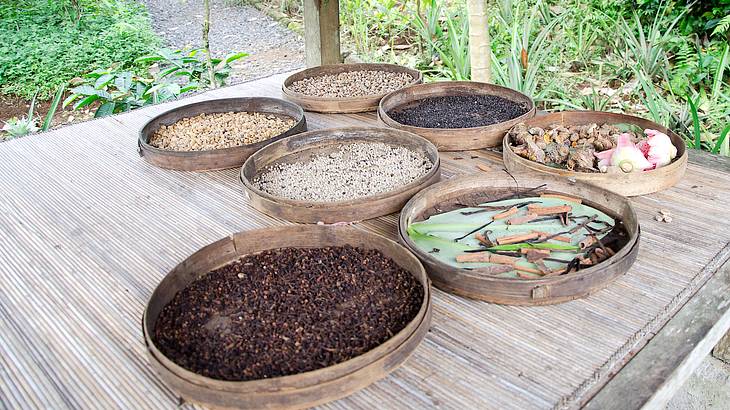 Different pans filled with items involved in the coffee making process