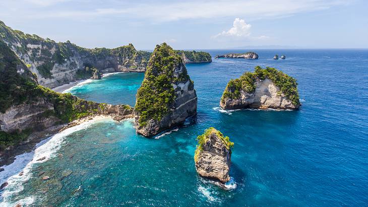 Many rock formations and cliffs surrounded by water from above