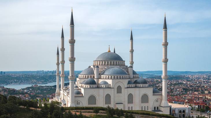 A large white mosque with dome roofs and minarets