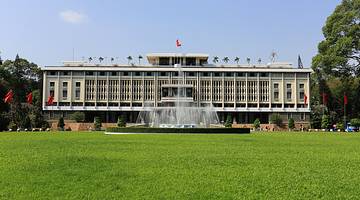 Outside grassy area with a fountain in front of the Independence Palace in Vietnam
