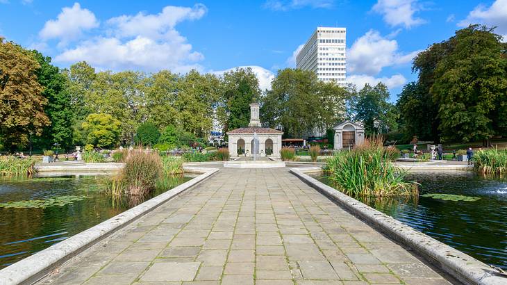 Italian Gardens with statue in middle and water on each side of path, London, UK