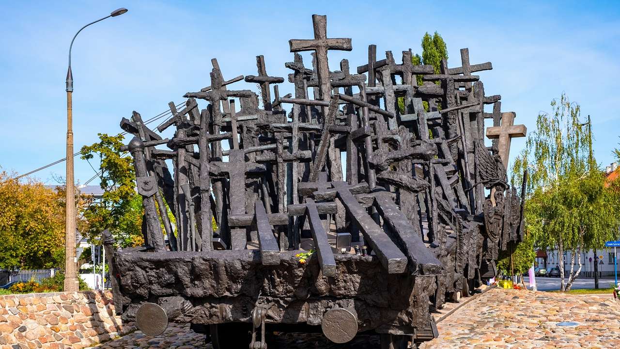 A stone structure of a railway flatcar with crosses on it
