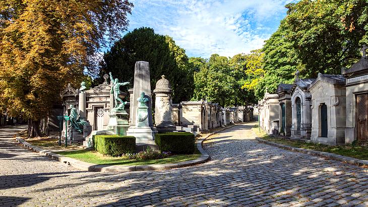 Unique and striking tombs, gravestones, and statues surrounded by trees