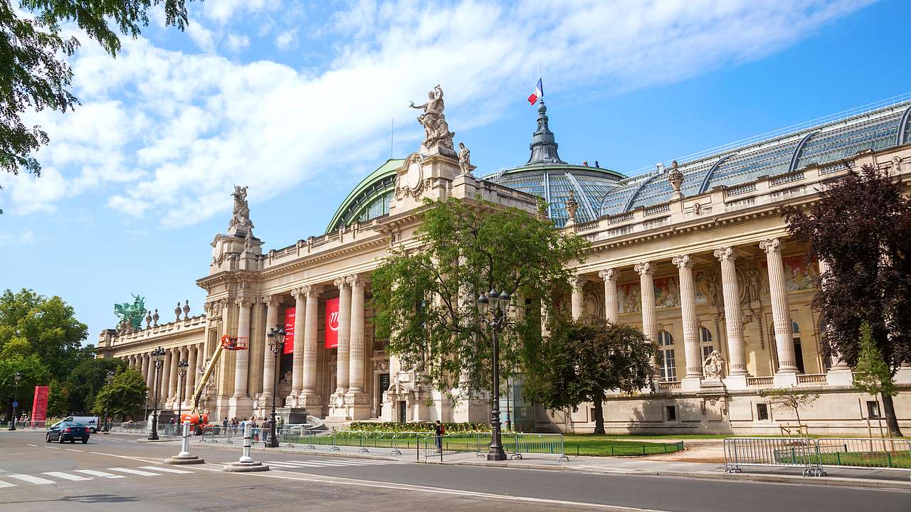 Grand Palais from the side facing a street with trees in front on a nice day