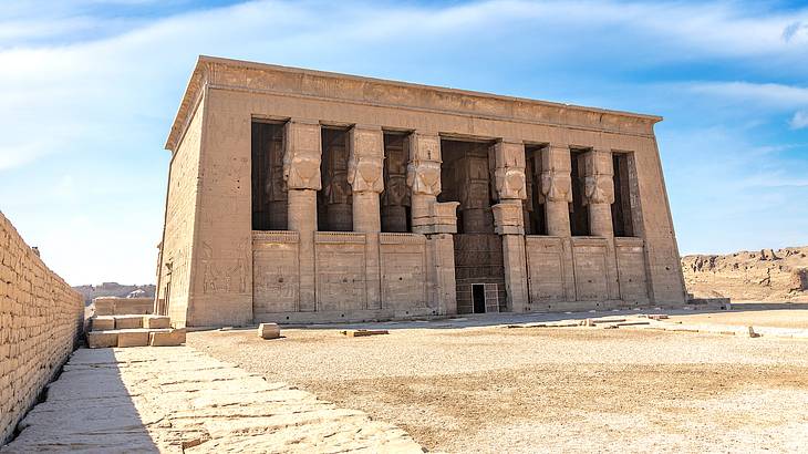 Full view of a grand Egyptian temple with ancient carvings on its exterior