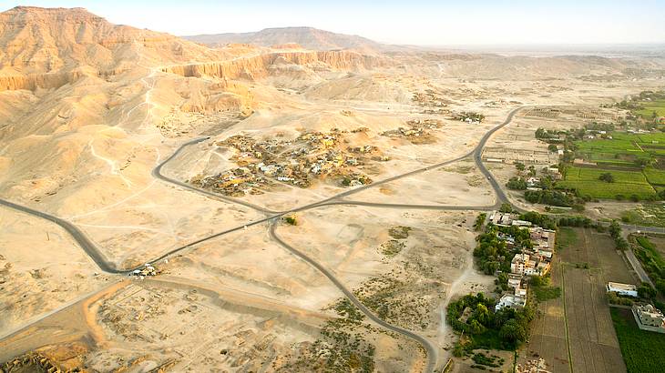Aerial view of the sun illuminating the Valley of the Kings and surrounding mountains