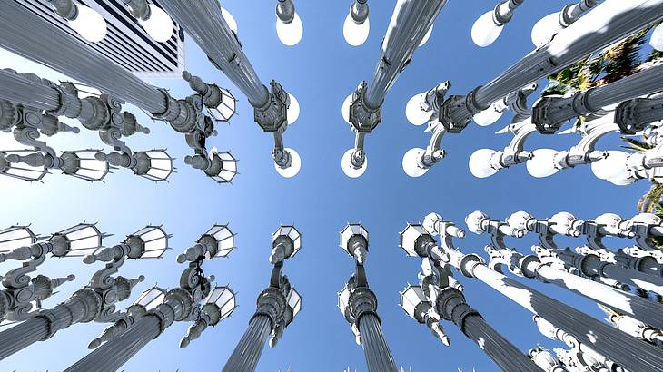 Bottom view of vintage street lamps under a blue cloudless sky