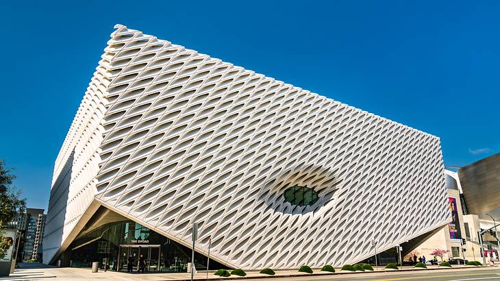 A modern white building under a blue sky from below