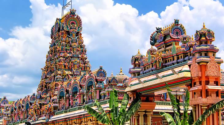 A Hindu temple's intricate rooftop filled with colourful deity statues