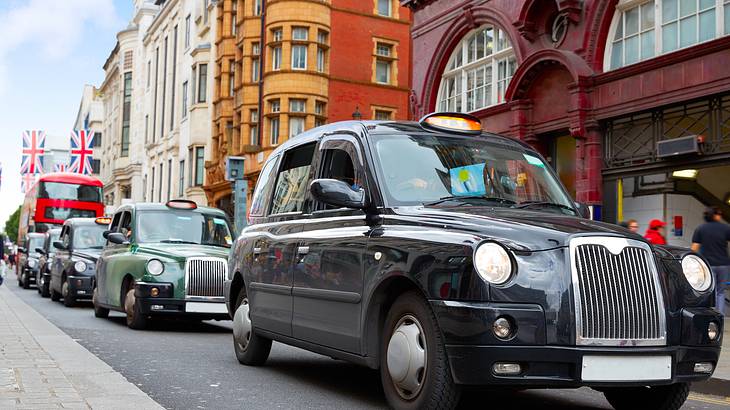 Black London Taxis on Oxford Shopping Street, London, UK