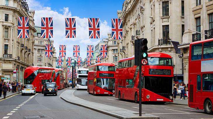 London's Regent Street with hanging British flags and red double-decker busses