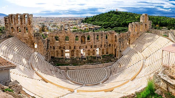A wide aerial shot of an ancient theatre with rows of descending seats