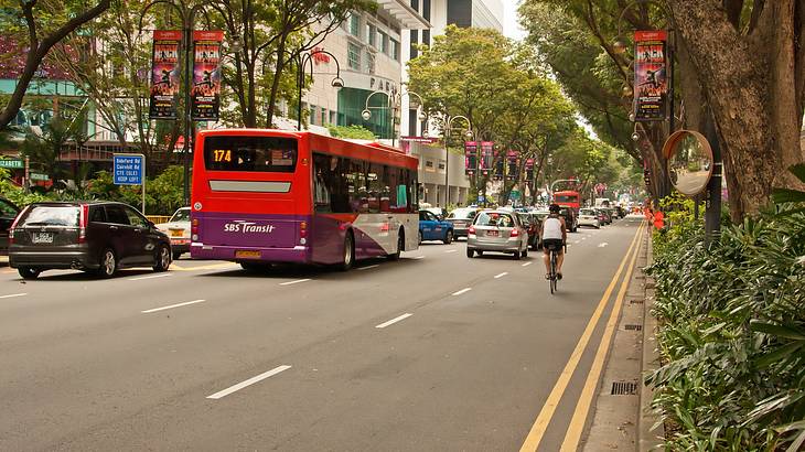 Busy Orchard Road with busses, cars and a cyclist, Singapore