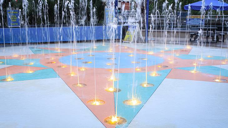 A fountain with a star shape in it and water shooting up