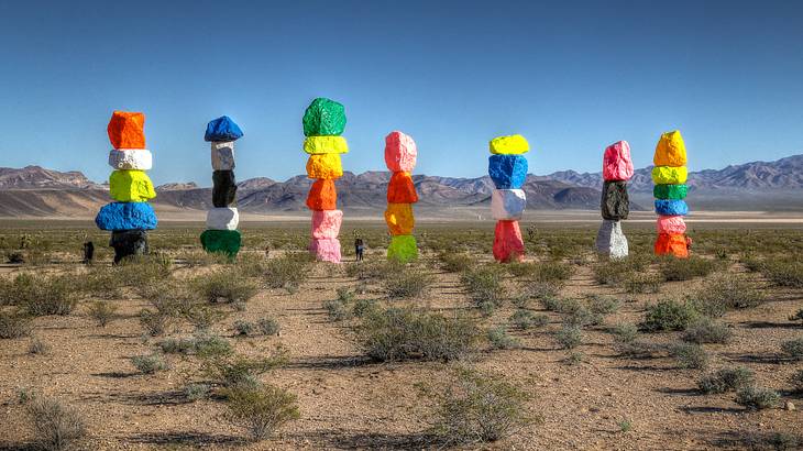 Seven towers of different colored stacked rocks in the desert