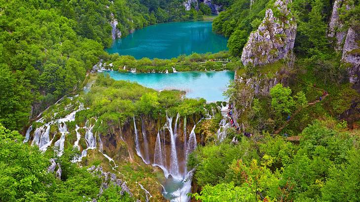 Two terraced lakes with waterfalls surrounded by trees