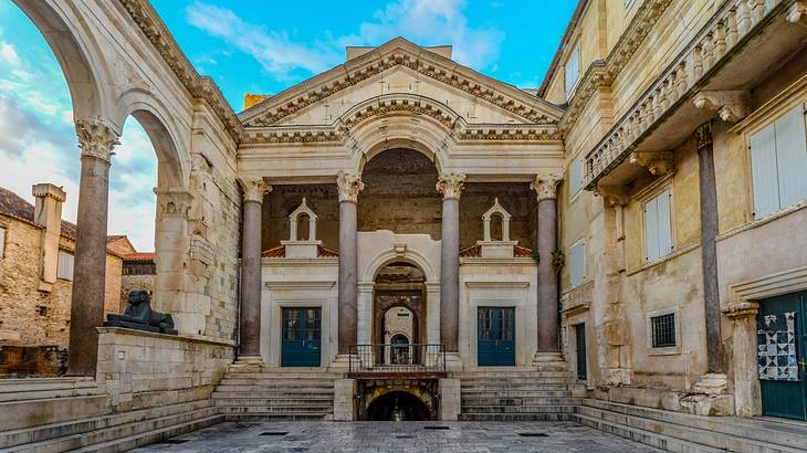 An interior part of an ancient palace with columns and arches